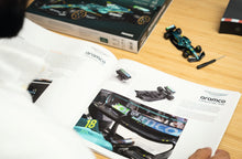 Load image into Gallery viewer, FRANZIS Aston Martin Aramco F1 Advent Calendar — AMR25 1:43 Model Kit with Engine Sound Base, A2 Poster & 52-Page Book