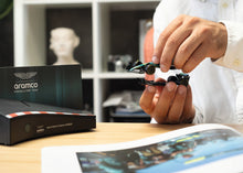 Load image into Gallery viewer, FRANZIS Aston Martin Aramco F1 Advent Calendar — AMR25 1:43 Model Kit with Engine Sound Base, A2 Poster &amp; 52-Page Book
