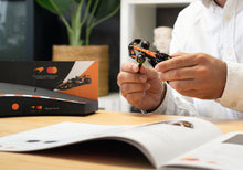 Load image into Gallery viewer, Franzis McLaren Racing Advent Calendar — MCL39 1:43 F1 Model Kit with Engine Sound Base, A2 Poster &amp; 52-Page Book

