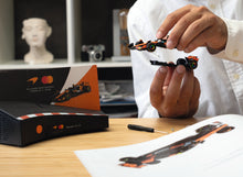 Load image into Gallery viewer, Franzis McLaren Racing Advent Calendar — MCL39 1:43 F1 Model Kit with Engine Sound Base, A2 Poster &amp; 52-Page Book
